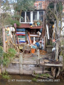 [Colour photo image of a Dawlish garden backing on to the brook]